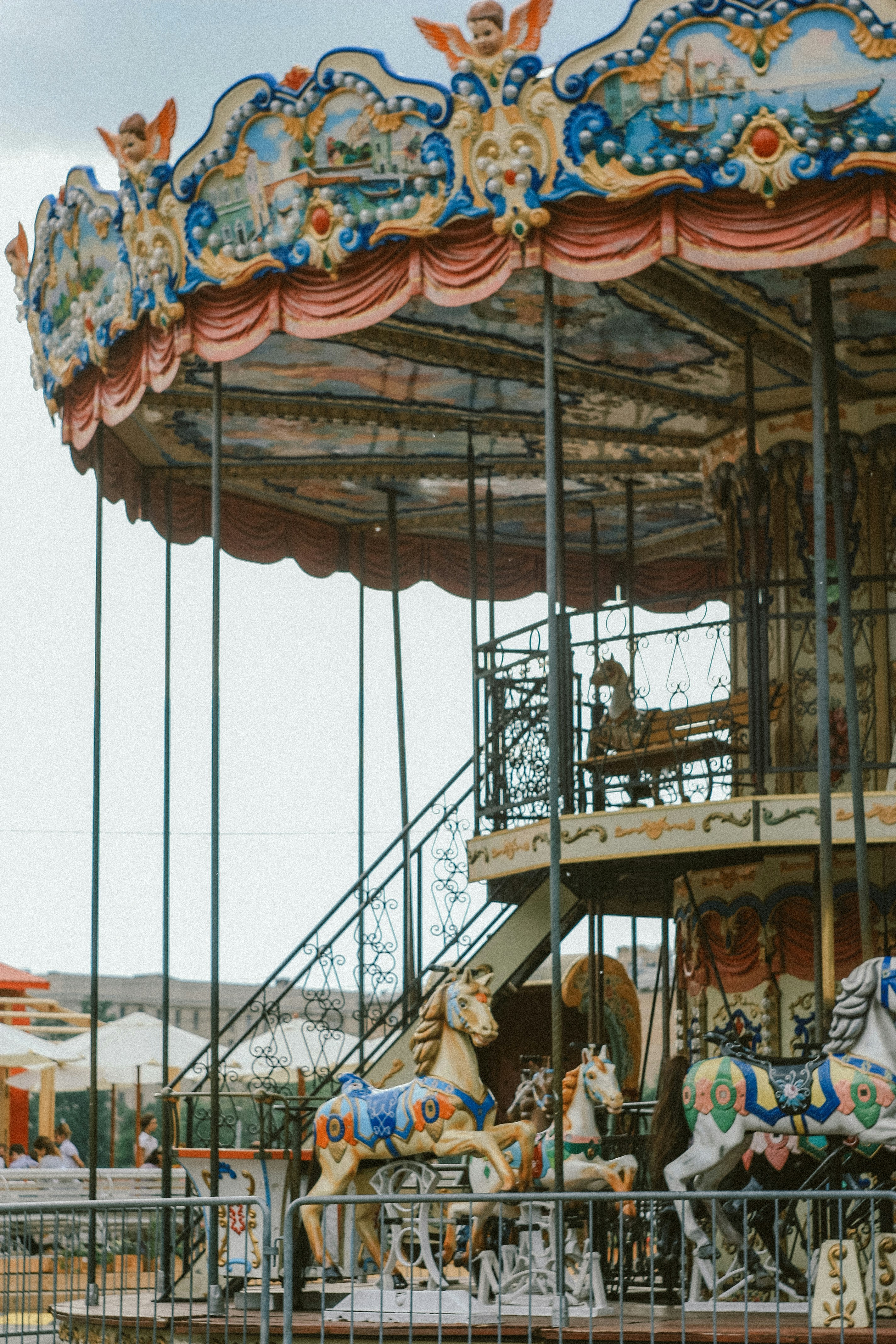 people riding on carousel during daytime